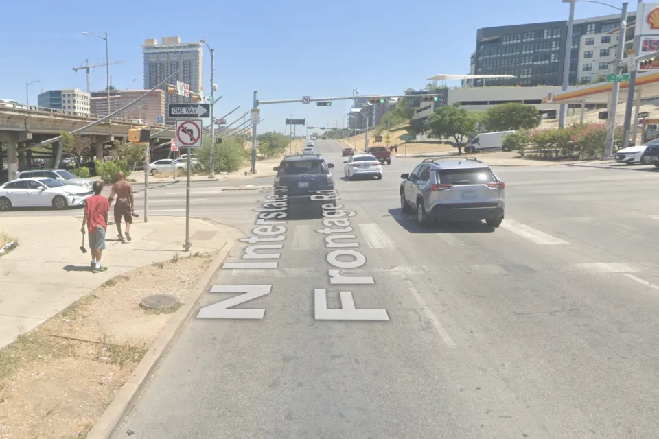 A concrete expanse is visible at the intersections of two wide roads in Austin, Texas.